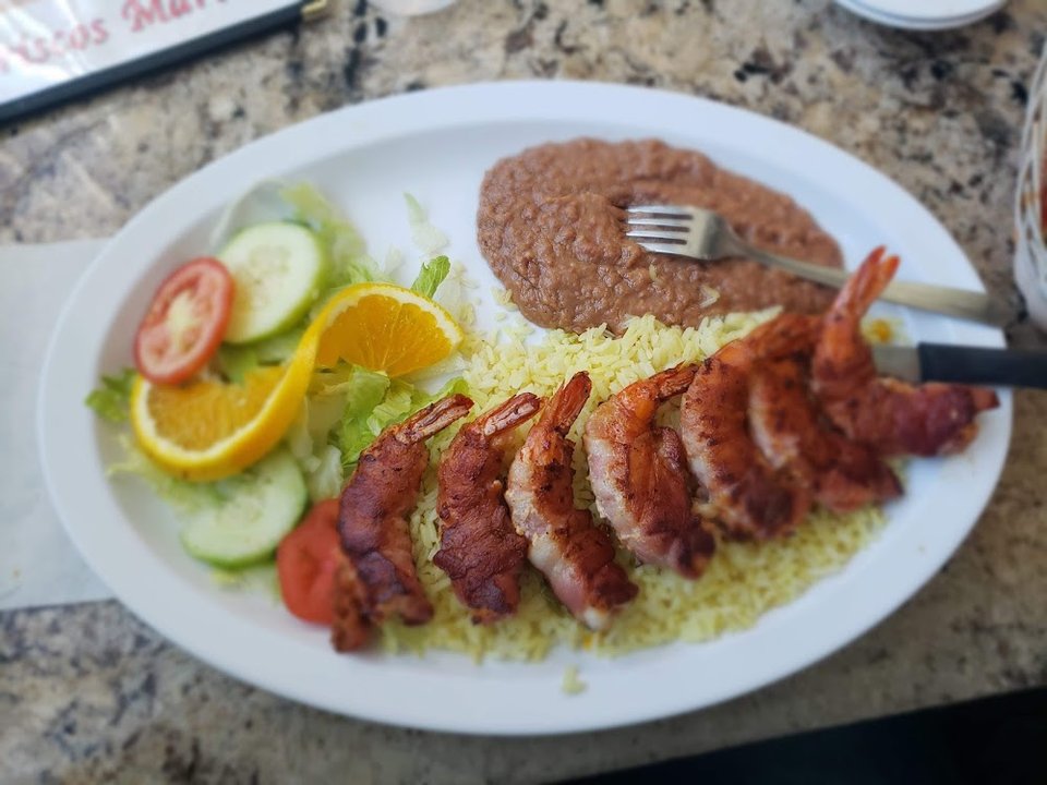 Printed menu with seafood and Mexican dishes.